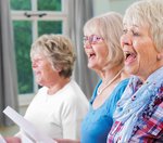 Ältere Frauen singen gemeinsam. 