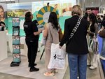 Eine Mitarbeiterin mit Besuchenden am Glücksrad